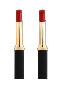 Deux rouges à lèvres avec un boîtier en métal doré brillant et une base noire mate. Les couleurs des lèvres sont un rouge éclatant avec une texture lisse.