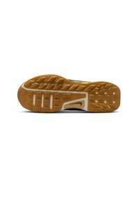 Trail running shoe sole featuring a rugged, textured gum rubber outsole with multiple grip patterns and a contoured shape for traction.