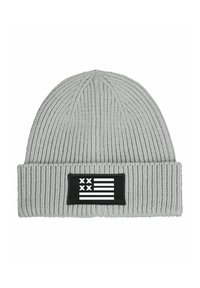 Gray knitted beanie with a ribbed texture. Features a rectangular black patch displaying a white flag design with five horizontal stripes and two stars.