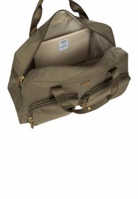 Borsa da viaggio in nylon verde olivastro con doppio manico, un ampio interno, zip dorate e una tasca esterna con zip.
