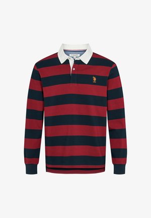 Rugby majica dugih rukava s širokim vodoravnim tamnoplavo-crvenim prugama, bijelim ovratnikom, prednjim zakopčavanjem na gumbe i narančastim USPA logotipom na prsima.