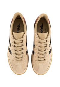 Zapatillas de ante beige con rayas negras, puntera redonda, diseño con cordones y suela de goma. Logo impreso en la lengua.