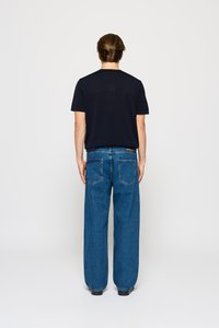 Czarny t-shirt z krótkim rękawem i niebieskie szerokie dżinsy, z jednolitym kolorem i standardowymi tylnymi kieszeniami, na neutralnym tle.