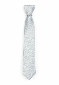 Cravate bleu clair avec un motif floral en blanc. Fabriquée en soie, elle présente une texture lisse et une pointe. Fixée avec un anneau en argent.