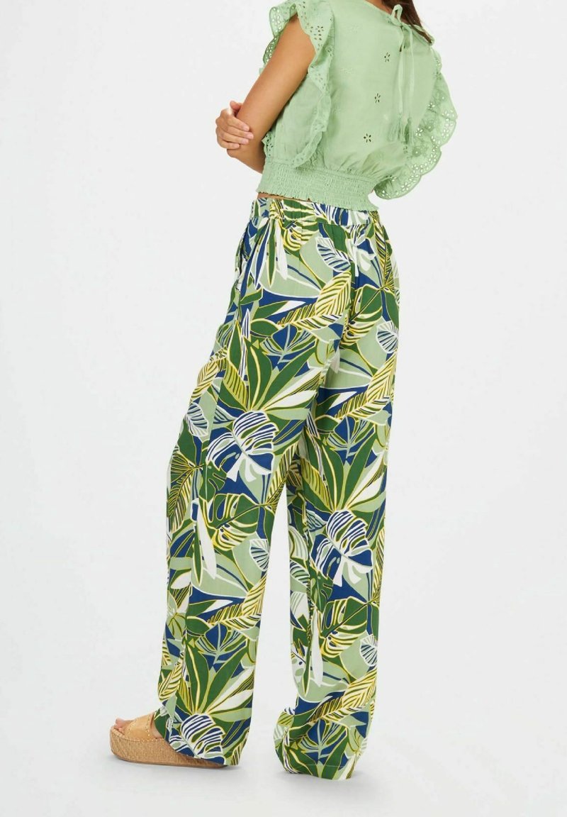 Pantalons larges à imprimé floral en vert, bleu et jaune. Tissu léger, taille élastique et cordon de serrage.