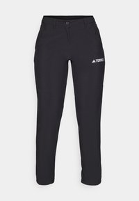 Schwarze Outdoor-Hosen aus einem strapazierfähigen Stoff. Mit einer taillierten Passform, ausgestattet mit einem Knopfverschluss und einem weißen Logo auf dem linken Oberschenkel.