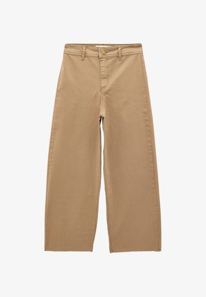 Beige vidde bukser med bæltestropper, frontknap og lynlåslukning, lavet af robust stof.