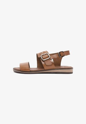 Brown leather sandals with a wide front strap and an ankle strap, featuring a metal buckle, cork insole, and flat rubber sole.