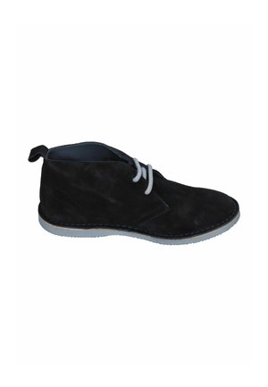 Black suede ankle boot with light gray sole and laces, side view, showing minimal stitching details and pull tab at the heel.