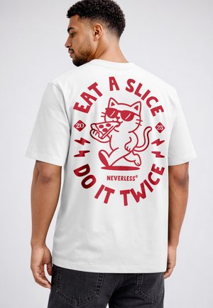 Man wearing white t-shirt with red graphic of cat eating pizza and text "Eat a slice I do it twice" on the back.