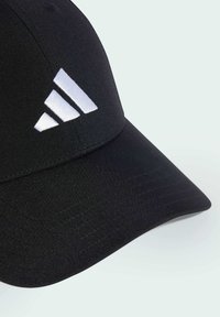 Black baseball cap with a curved brim, featuring a white embroidered Adidas logo on the front. Made of smooth, lightweight fabric.