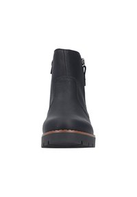 Bottine en cuir noir à bout arrondi, avec fermeture éclair sur le côté, tige texturée et semelle en caoutchouc présentant un motif en vagues et un contour marron.
