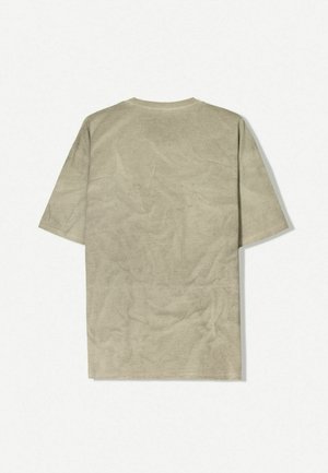Cotton t-shirt, light beige color, relaxed fit, short sleeves, crew neckline, smooth texture with slight wrinkling, no graphics or embellishments.