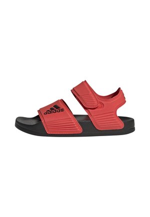 Red and black Adidas sandal with adjustable Velcro straps and cushioned sole shown in side profile on white background.