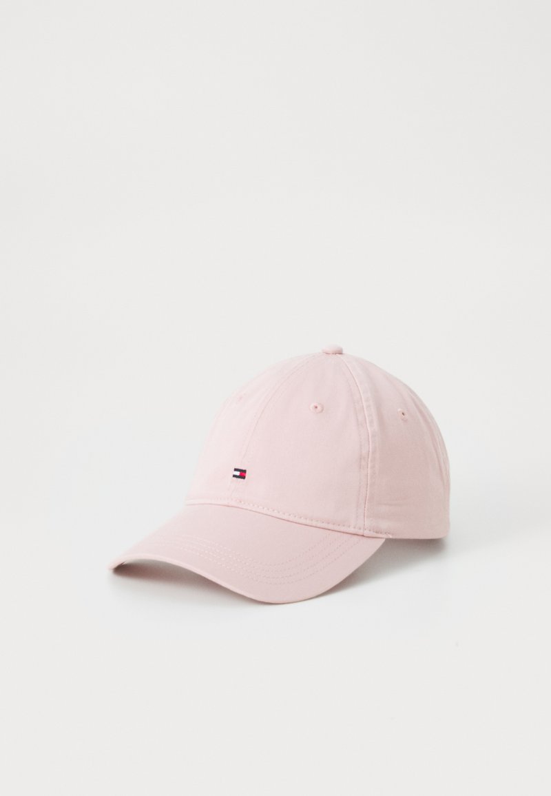 Pink cotton cap with a curved bill, featuring a small logo patch in dark blue, red, and white. Stitched accents on the brim and panels.