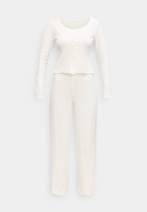 White ribbed knit long-sleeve buttoned top and matching high-waist wide-leg pants set with lettuce-edge hems.