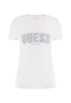 Vitt t-shirt med kort ärm i bomull, med en glittrande "GUESS"-logotyp prydd med strass och "EST. 1981" under. Slät textur, figurnära design.