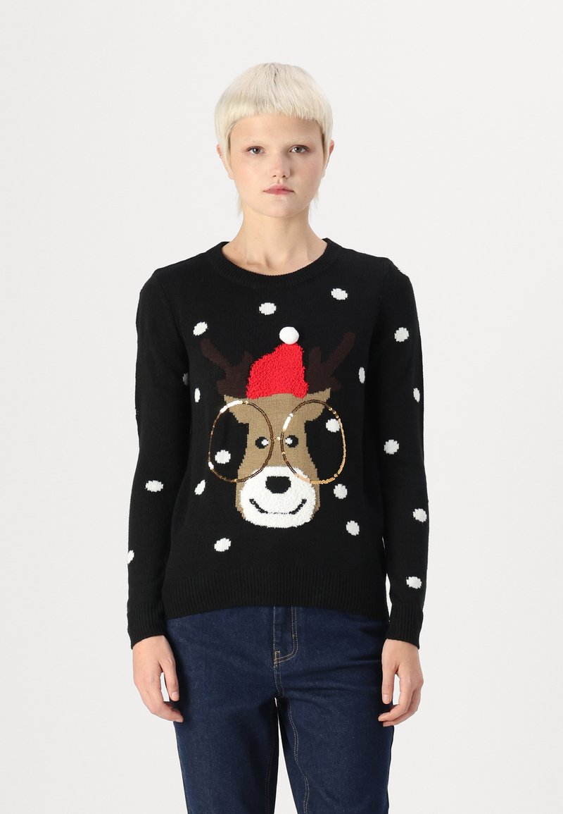 Pull en tricot noir avec le visage d'un renne de dessin animé portant des lunettes, un chapeau rouge et des pois blancs, mettant en valeur une texture douce et un design ludique.