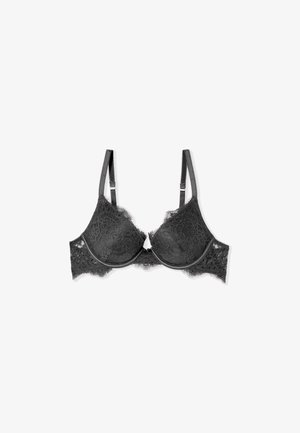 Reggiseno nero in pizzo con ferretto, spalline regolabili e bordi smerlati, mostrato disteso su uno sfondo bianco.
