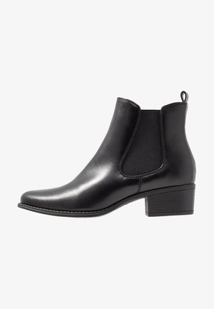 Black leather ankle boot with elastic side panels, pointed toe, and a low stacked heel. Features a pull tab at the back.