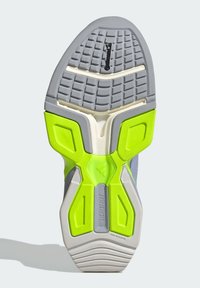 Sole of a sneaker featuring a grey and white base with bright green accents. Textured tread pattern for grip, with a lightweight design.