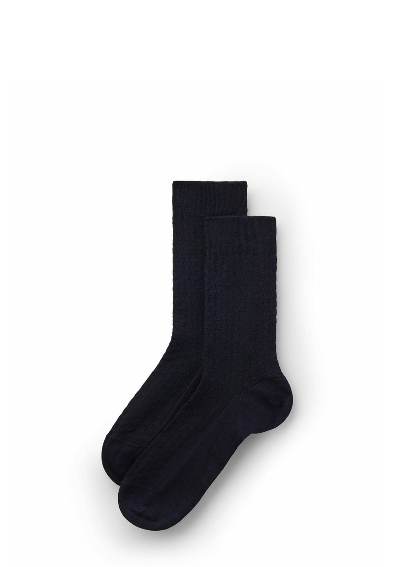 Calcetines azul marino con un patrón texturizado y trenzado. Longitud hasta la mitad de la pantorrilla, con un color sólido en todo y un acabado suave.