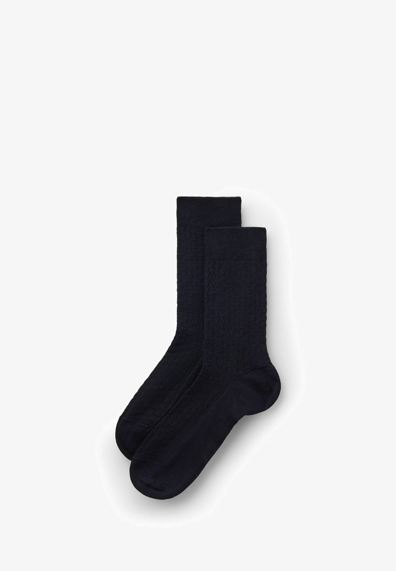 Calcetines azul marino con un patrón texturizado y trenzado. Longitud hasta la mitad de la pantorrilla, con un color sólido en todo y un acabado suave.