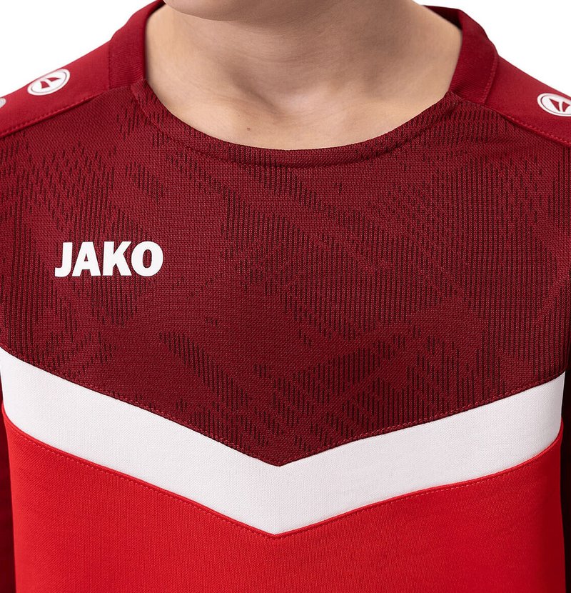 Rode sportshirt met ronde hals, textuurdesign, witte streep over de borst en 'JAKO'-logo in het wit op de voorkant.