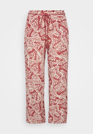 Pantalons à motifs rouges et crème avec une taille élastique et un cordon de serrage ajustable. Le tissu présente un motif floral et une coupe décontractée.