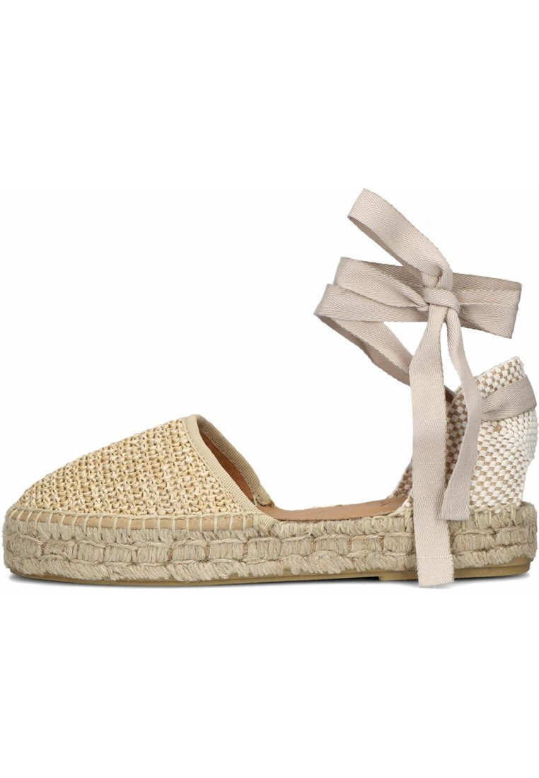 Woven natural fiber espadrille with a rounded toe, beige color, leather insole, and fabric ankle ties; braided jute sole.