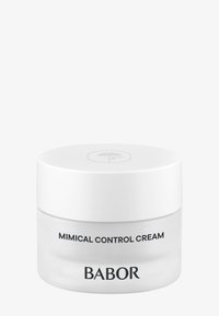Bocal en verre rond avec un fond transparent et un couvercle blanc. L'étiquette présente "Crème de Contrôle Mimical" et "BABOR" en texte noir. Design simple.