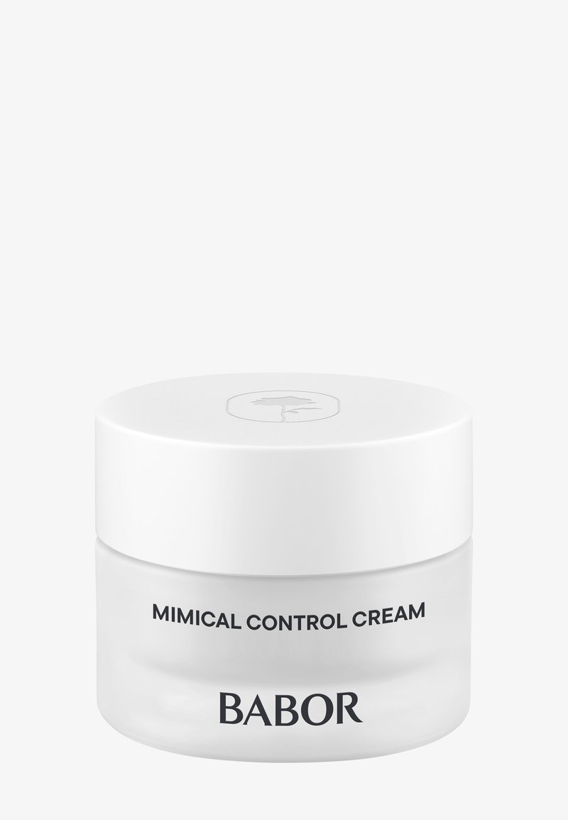 Bocal en verre rond avec un fond transparent et un couvercle blanc. L'étiquette présente "Crème de Contrôle Mimical" et "BABOR" en texte noir. Design simple.