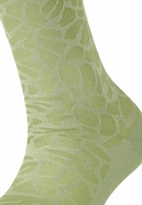 Chaussettes à motifs verts avec un design texturé comportant différentes formes, fabriquées dans un matériau doux et extensible, idéal pour le confort.