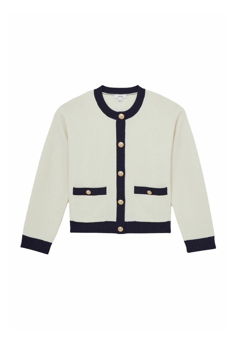 Ivory jopica z mornimi modrimi detajli, s krožnim izrezom, zlatimi gumbi in dvema sprednjima žepoma. Narejena iz mehke, teksturirane tkanine.