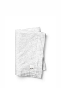 Vitt kviltat bomullsöverdrag med strukturerat prickmönster, vikt prydligt. Litet varumärkesmärke i hörnet. Mjukt och lätt material.