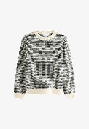 Pull en tricot avec un col rond, présentant un motif en noir et blanc, et des poignets et un ourlet côtelés de couleur crème.