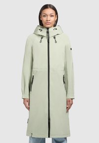Light green long coat with a zipper front, drawstring hood, two side pockets, and black hardware accents. Made of smooth, water-resistant material.