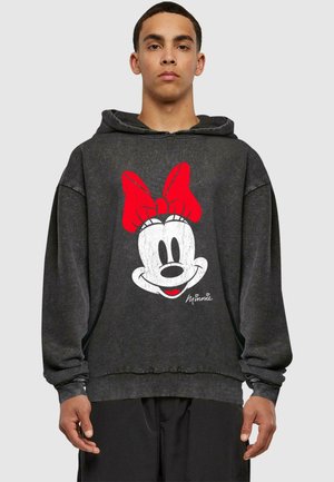 Black hoodie with a large, distressed white Minnie Mouse graphic featuring a red bow. Ribbed cuffs and hem. Loose fit design.