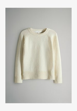 Krémový sveter s textúrovaným pletením, rebrovaným okrajom okolo krku a manžetami. Dlhé rukávy s voľným strihom, s jednofarebným dizajnom a minimálnymi detailmi.