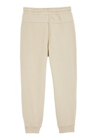 Beige sporta bikses ar mīkstu, gludu tekstūru, elastīgu jostu un ribotām aprocēm pie potītēm. Vienkāršs, taisnais griezums.