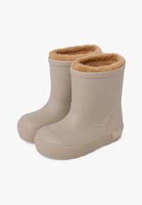Botas de goma beige con una suela texturizada y un suave forro de piel sintética en tono marrón claro. Cuentan con punta redondeada y un ligero tacón. Nombre de la marca visible en el lateral.