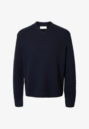 Pleteni tamnoplavi pulover s V-izrezom, teksturiranom površinom i dugim rukavima. Ima rebrasti ovratnik i manžete, te opušteni kroj.