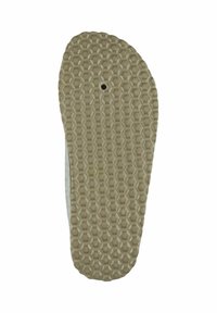 Rubber shoe sole with a honeycomb texture, beige color, featuring a small central hole. Curved shape towards the edges.