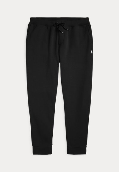 Sorte joggingbukser med elastisk taljebånd og snøre, sidelommer, ribkant ved anklerne og en lille hvid logo på højre hofte.