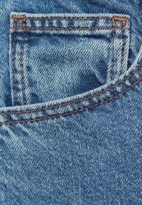 Denim pocket in blue fabric, featuring contrasting brown stitching and a worn texture. Pocket opening is rectangular with rounded corners.