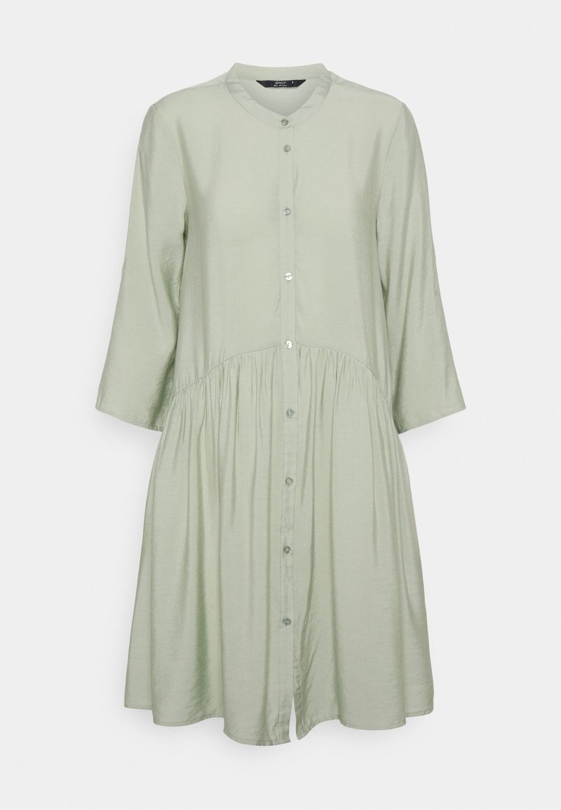 Light green, button-up dress with a round collar, three-quarter sleeves, and gathered waist. Made of smooth fabric, it has a relaxed fit.