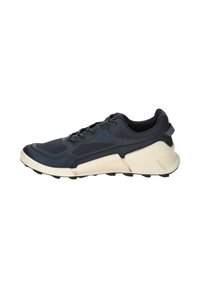 Navy running shoe with a textured upper, lace-up closure, and a thick white midsole. Features a ribbed heel and multiple traction studs on the sole.