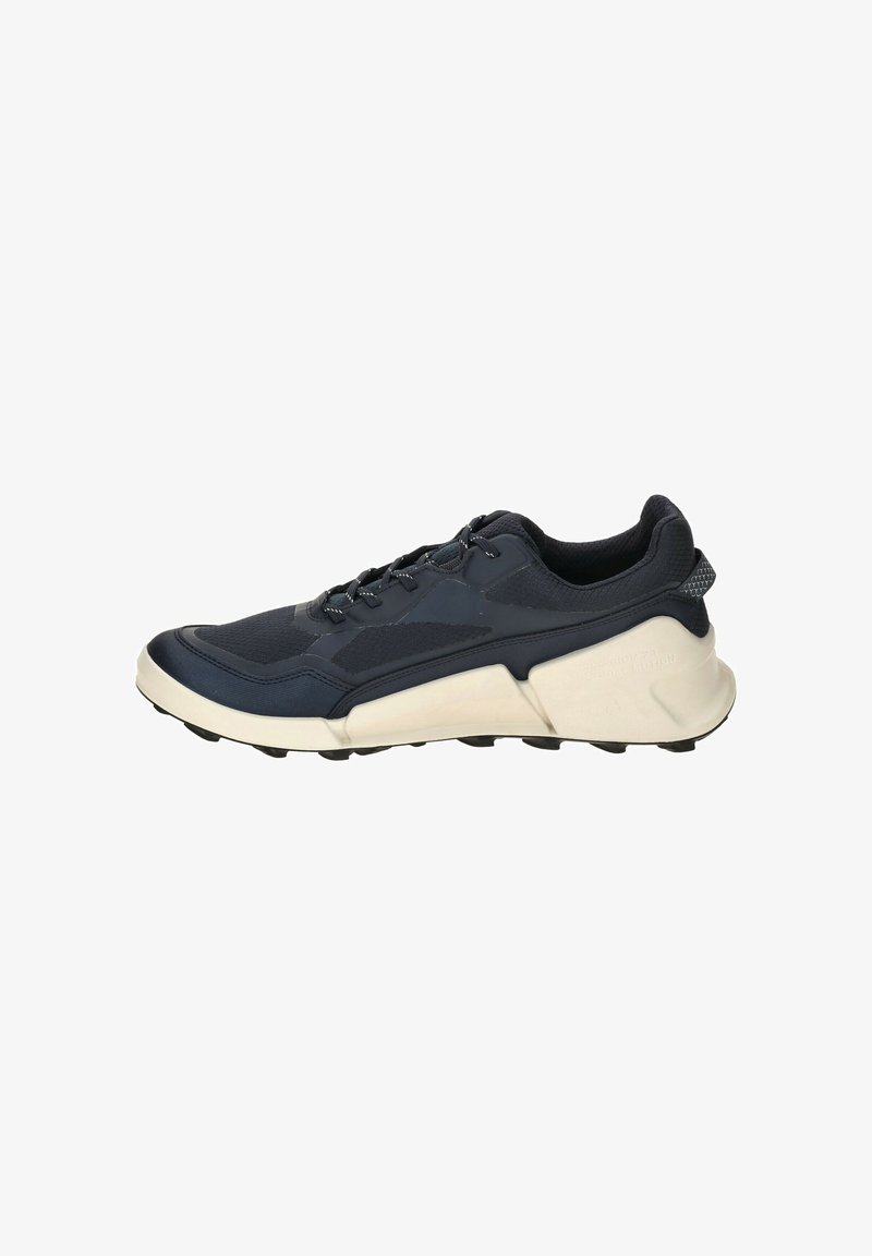 Navy running shoe with a textured upper, lace-up closure, and a thick white midsole. Features a ribbed heel and multiple traction studs on the sole.