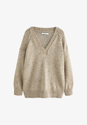 Beige strikket sweater med V-hals, ribbede manchetter og kant. Teksturen har et spottet mønster, der forbedrer den visuelle detalje.
