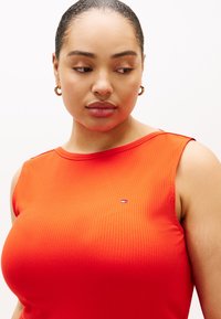 Κόκκινο μπλουζάκι χωρίς μανίκια με ριμπ ύφανση, στρογγυλή λαιμόκοψη και μικρό κεντημένο λογότυπο στο στήθος.